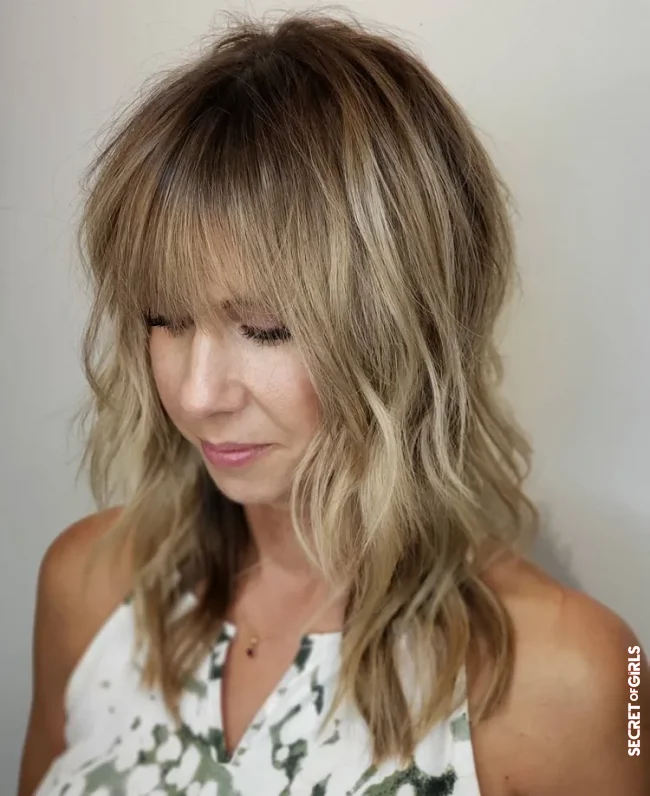 Layered cut for long hair combined with blunt bangs | Upbeat Hairstyles 2022 For Women Over 50