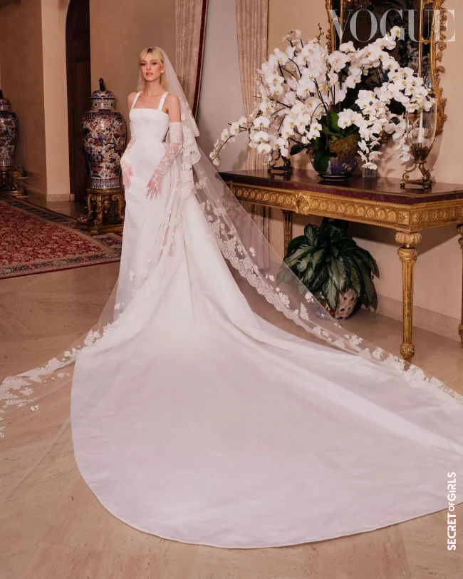 Wedding dress: XXL train and transparent gloves | Nicola Peltz's Bridal Hairstyle: She Combined Her Curtain Bangs and Veils So Beautifully for The Wedding