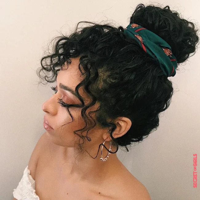 High bun with a scrunchie | Hairstyle Trends Fall 2023: 12 Perfect Hairstyle Ideas For Curly Hair