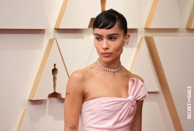 Zo&euml; Kravitz wears a pair of stylish mini bangs to one side and pulls the rest of her hair back closely, accentuating her cheekbones in addition to the dark bronzer | Oscars 2023: These are The Best Beauty Looks on The Red Carpet