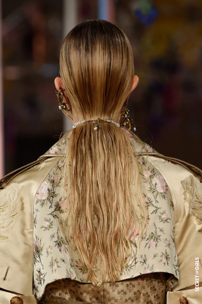 A model with wet hair looks at the Alexander McQueen Show in Paris. | Hairstyle Trend: Fascinating Slick Look and Wet Hair Look