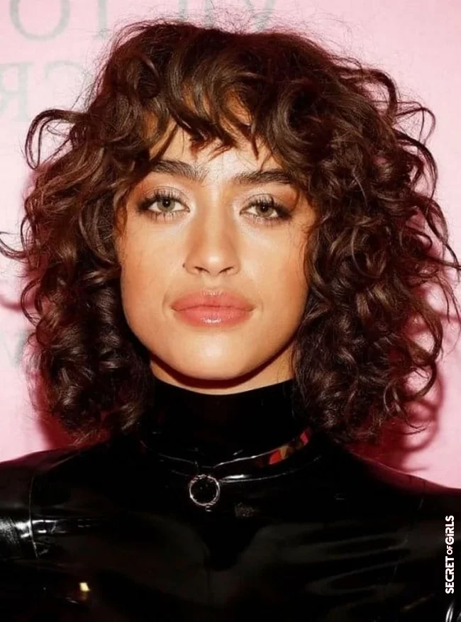 The tightly curled layered bob is one of a kind | Layered Bob With Bangs: Chic Variations on the Most Popular Hairstyle Trend of 2022